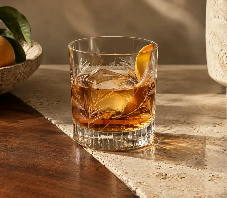 Engraved whiskey tumbler on travertine